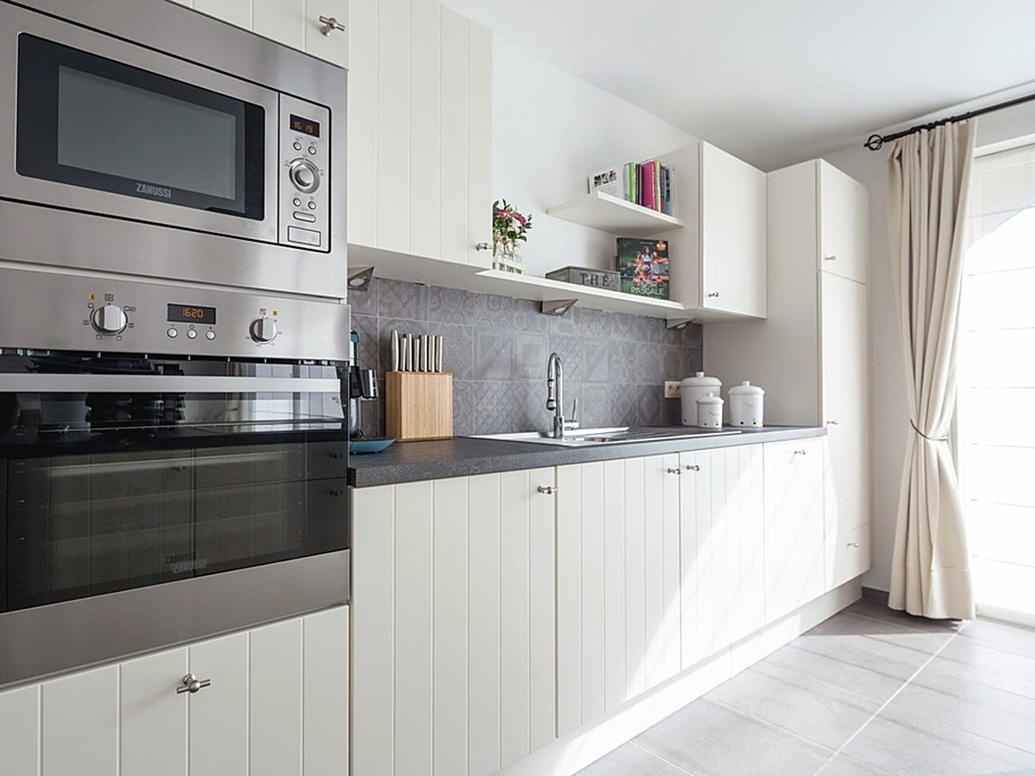 Bright modern kitchen with white cabinetry cleaned to a shine